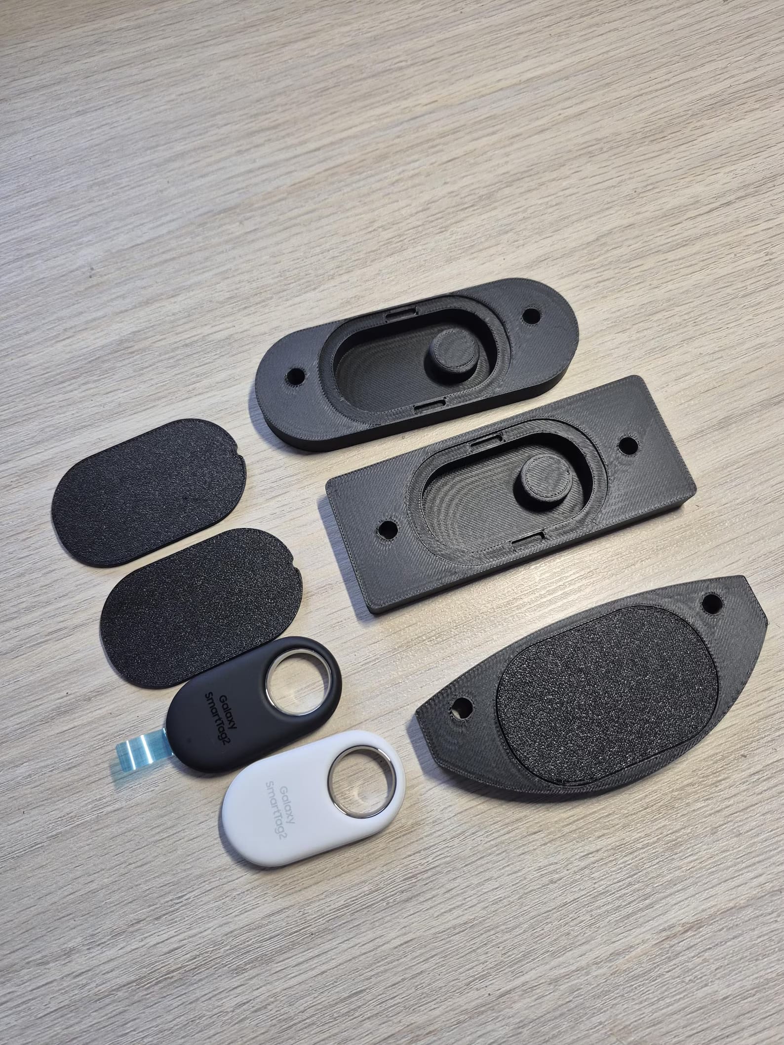 SmartTag bike mount components laid out - all variants and foam pads