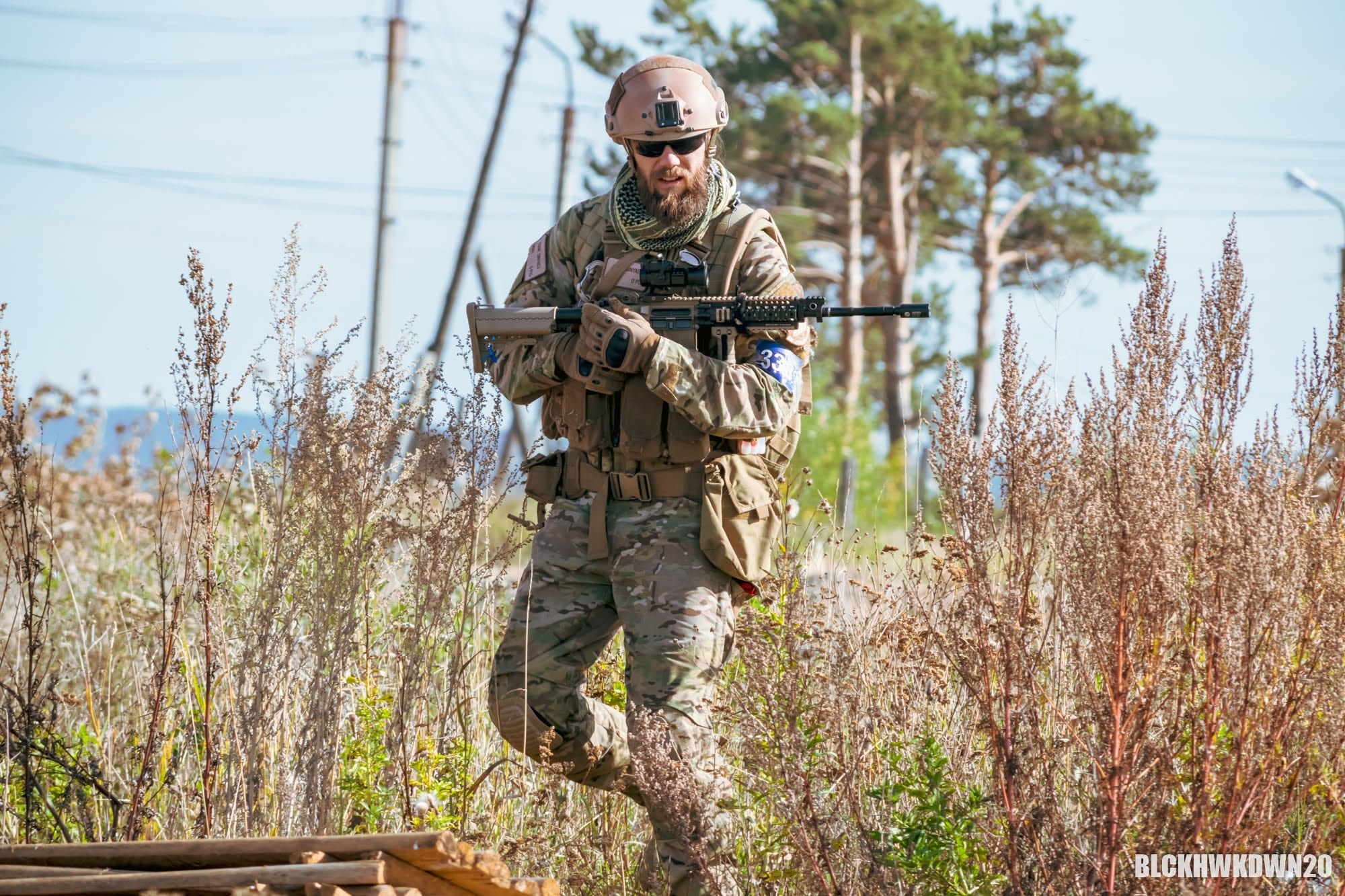 Moving through field in full kit